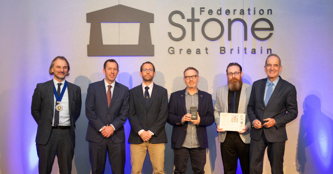 Gary Price and Lee Andrews pose for a photo with judges after winning award