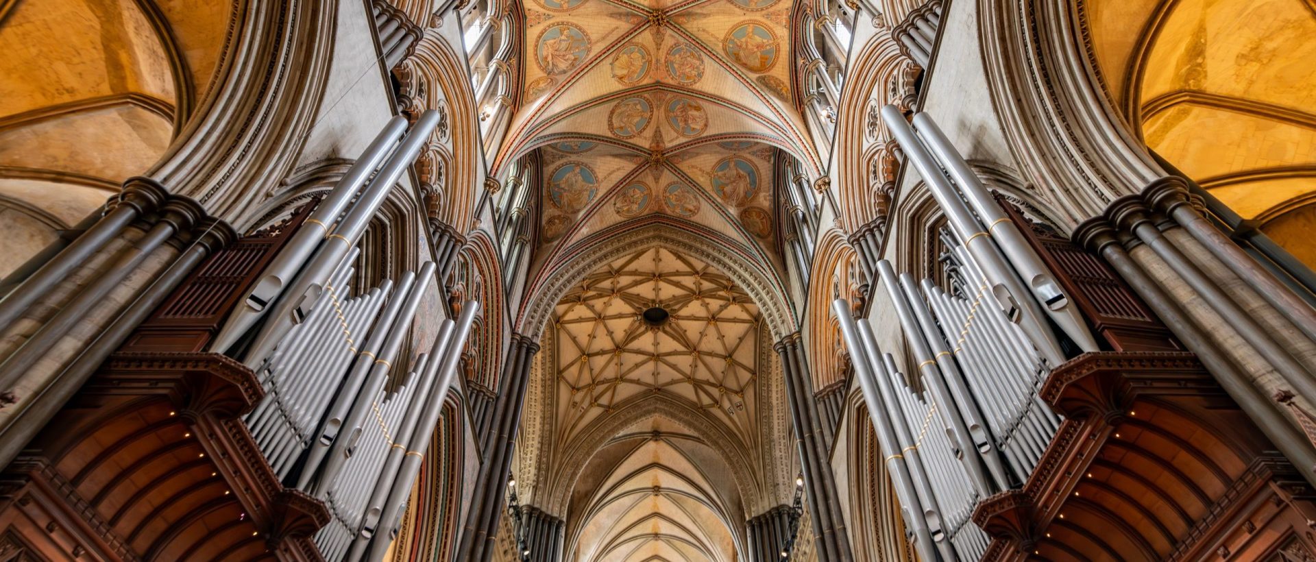Photo shows the organ pipes and surrounding arches and ceiling