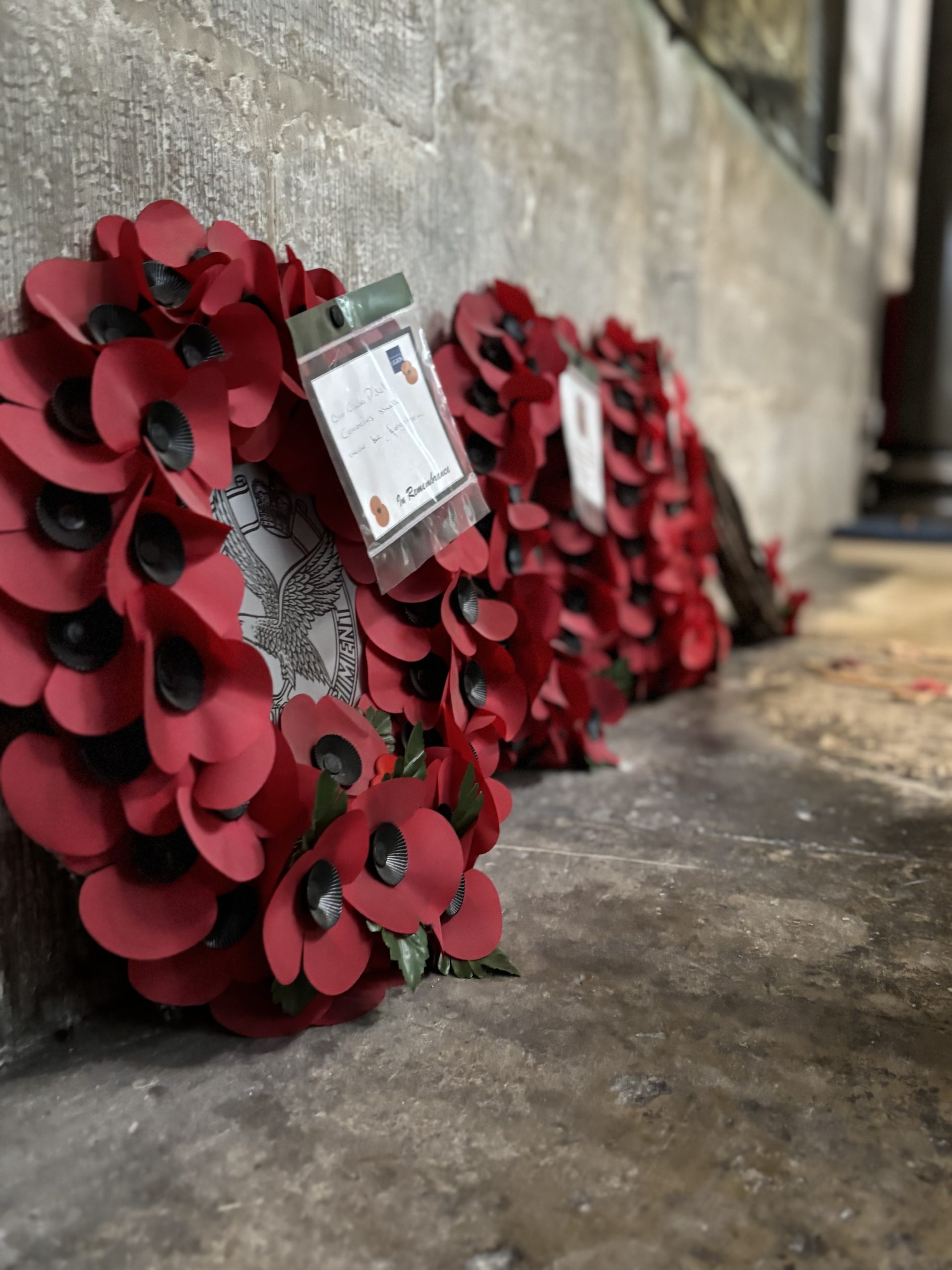 A wreath of poppies on a stone plinth