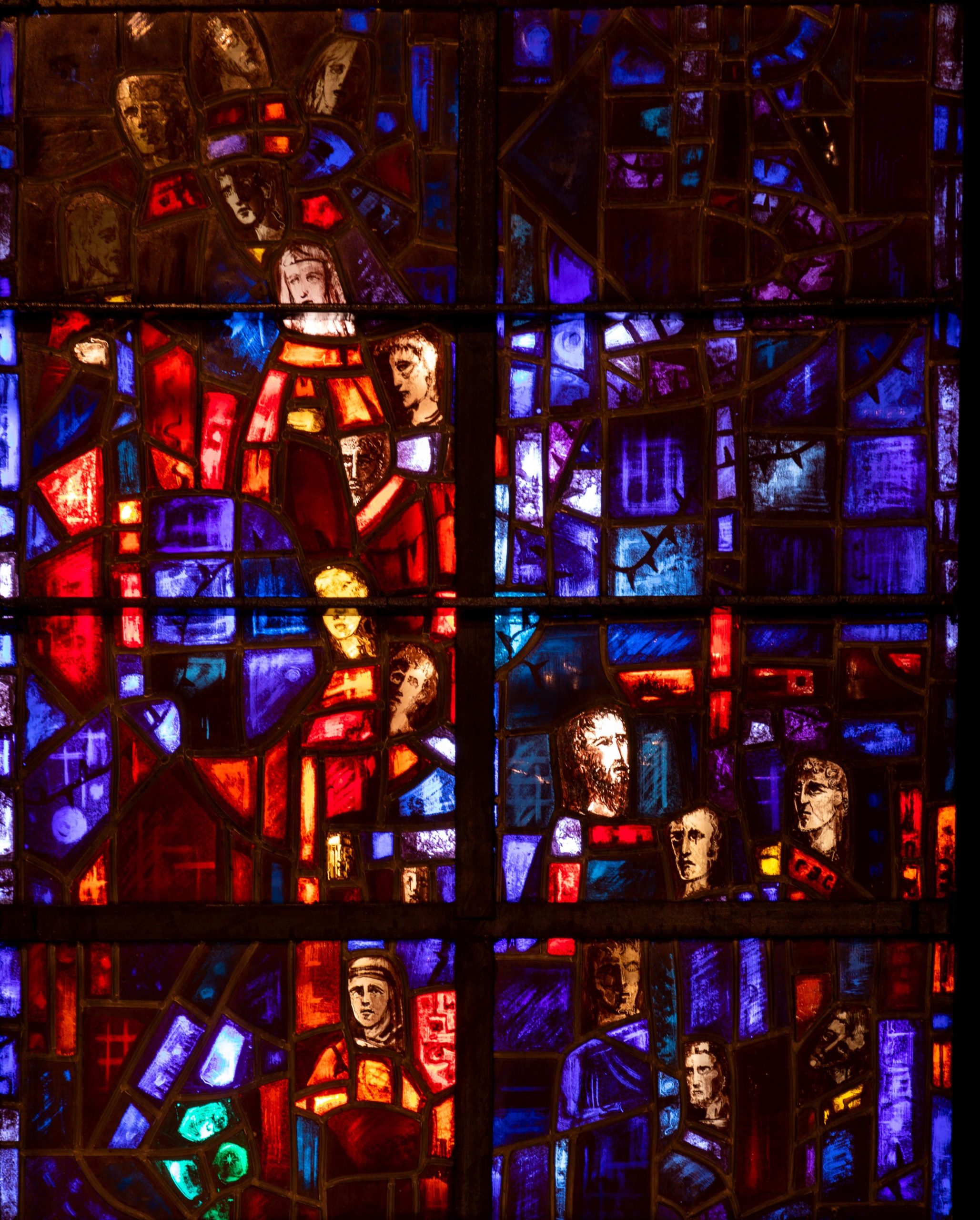 Detail of stained glass window showing various saints.