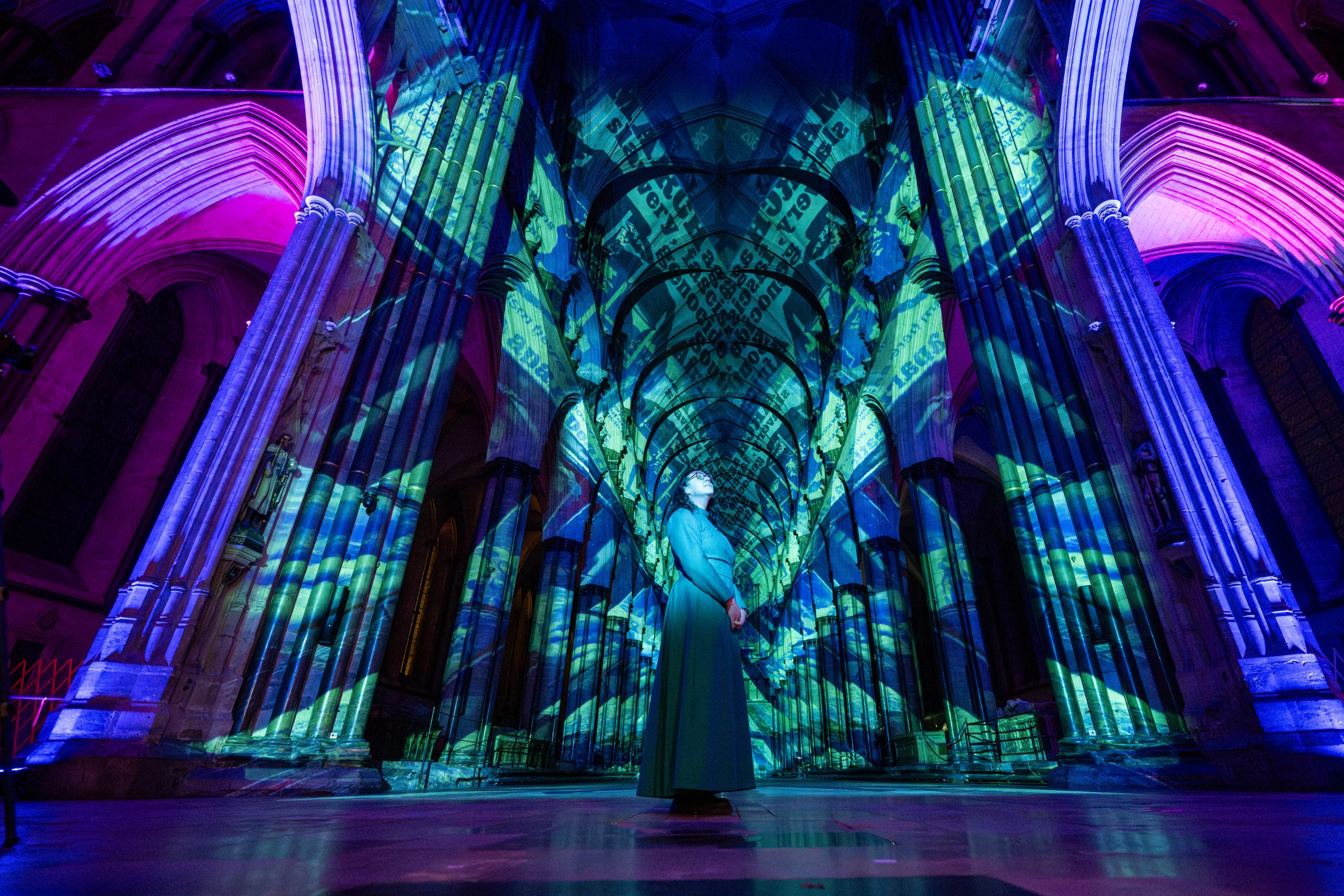 A wide view of the Cathedral nave, covered in colourful projected images