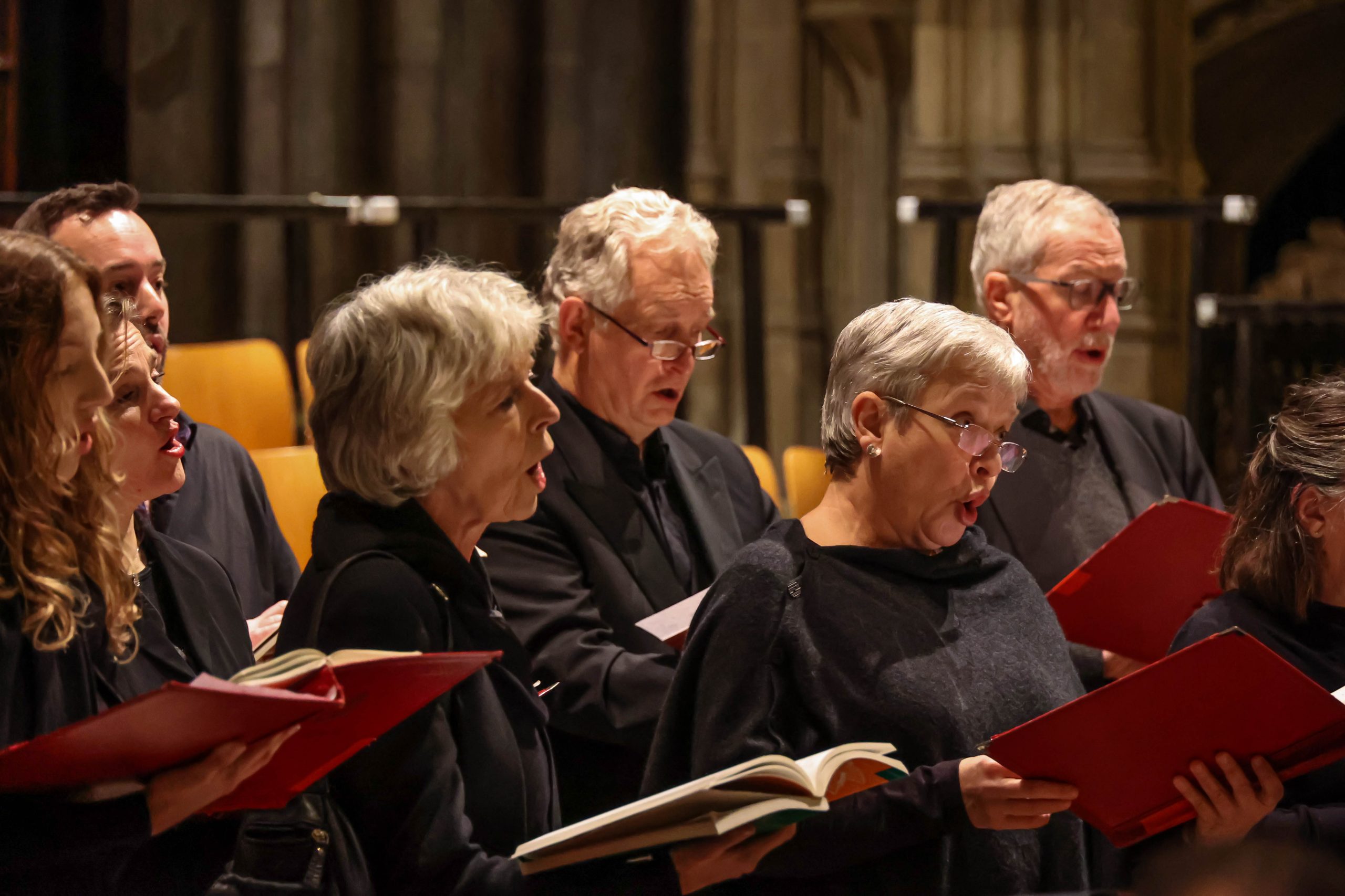 A mixed group of choir members singing inside the Cathedral