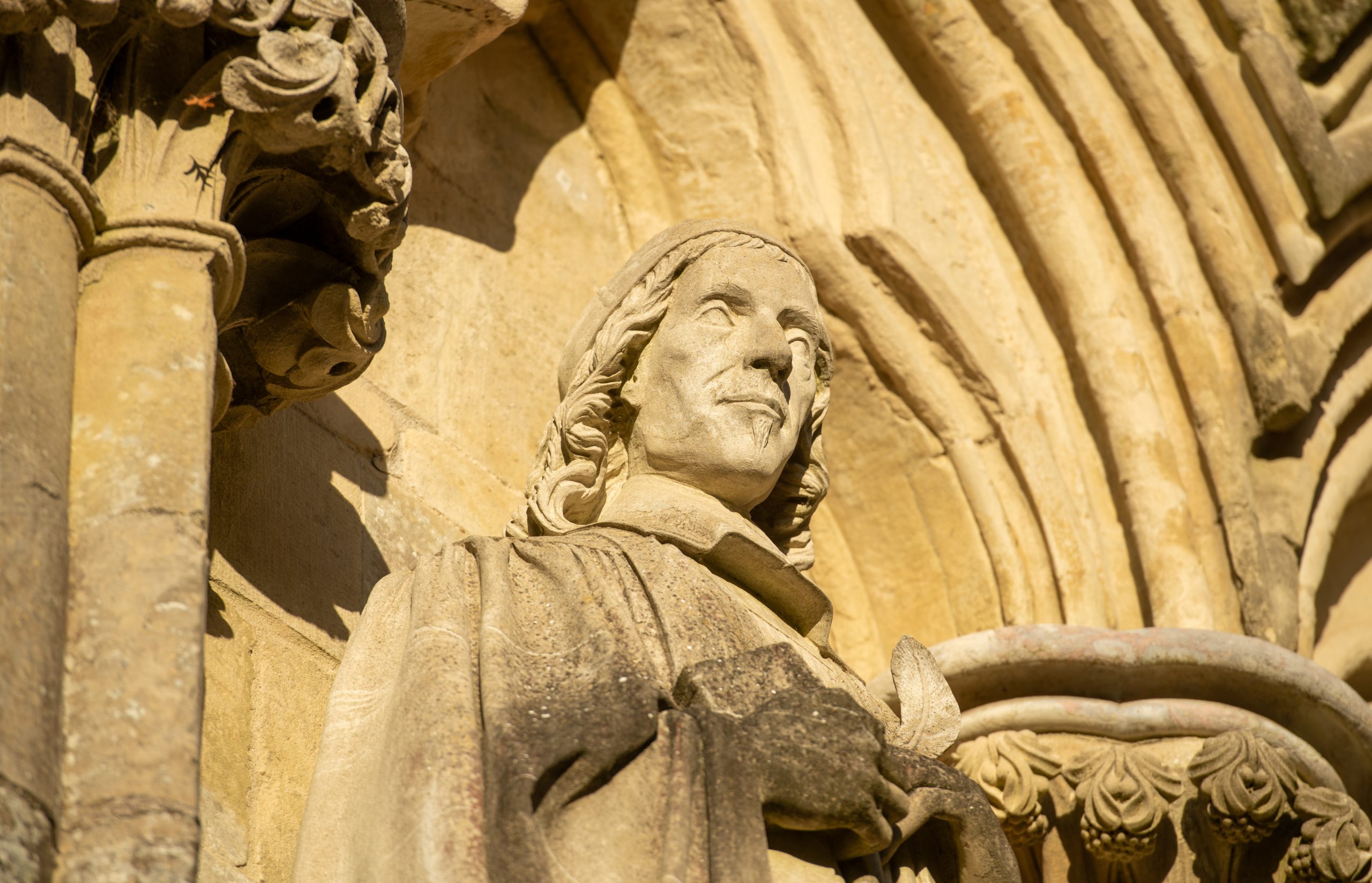 Photo shows detail of statue of George Herbert on the West Front of the Cathedral