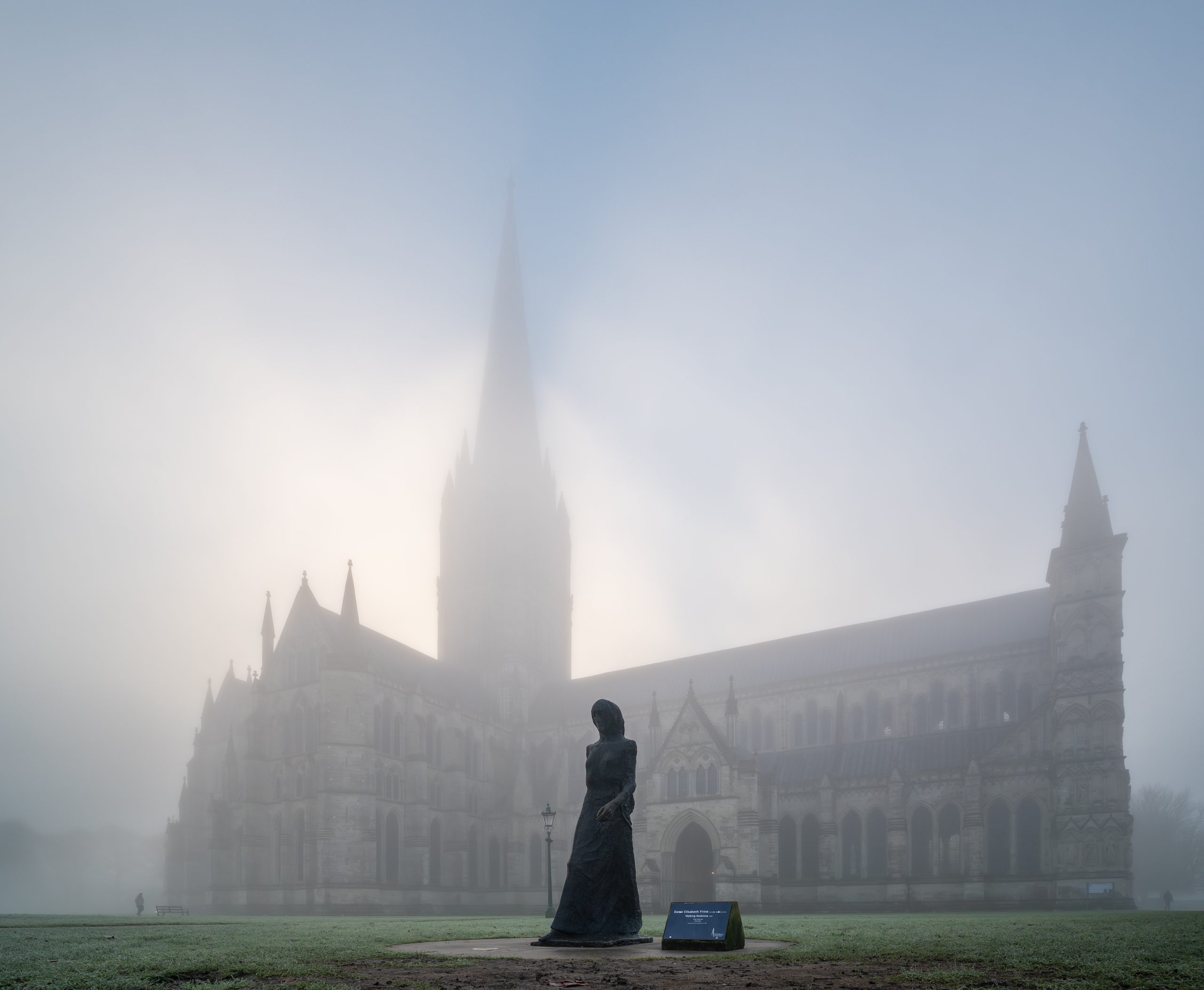 View of the North side of the Catehdral in the mist, with bronze sculpture of the Walking Madonna in the foreground