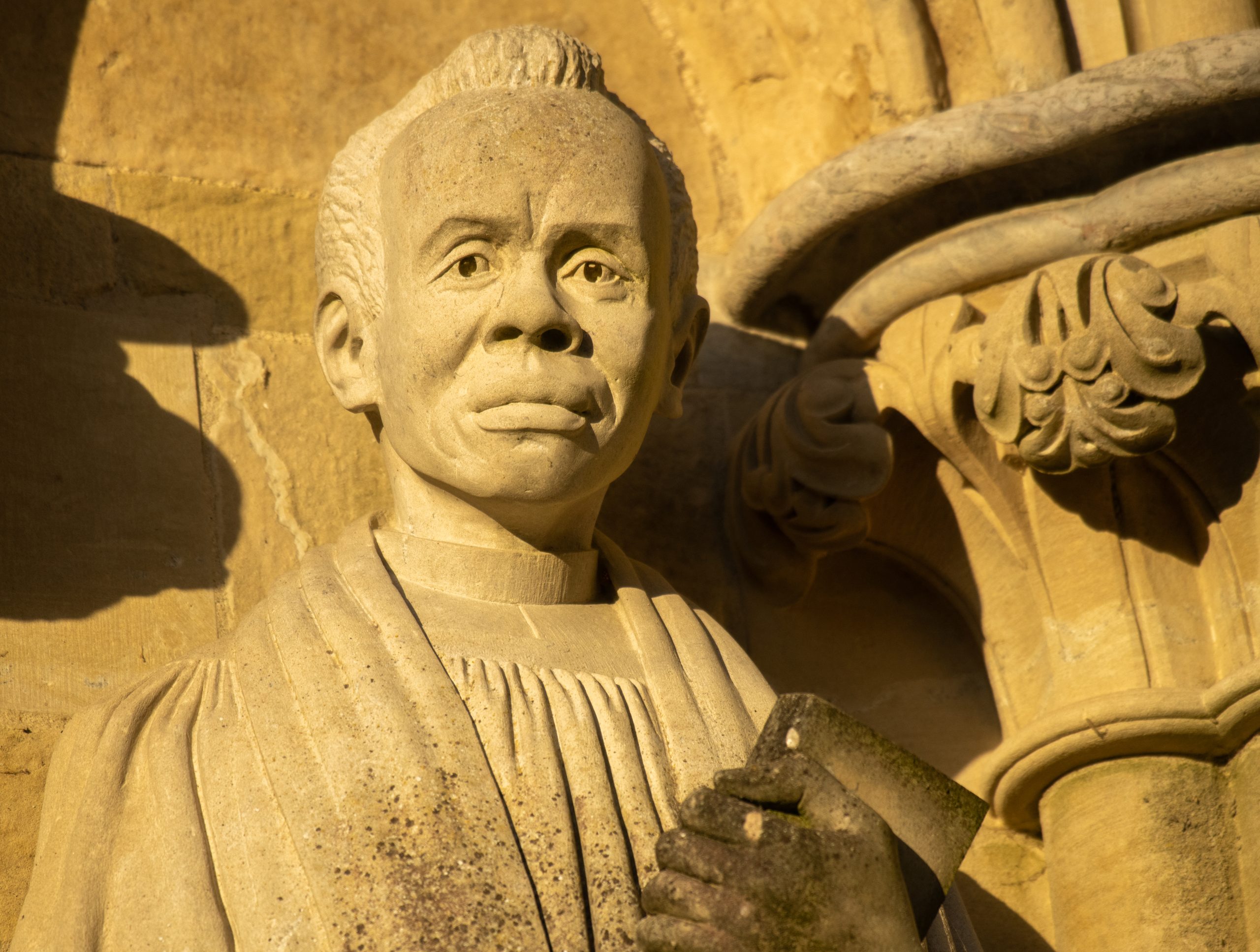 Detail of the carved stone statue of Canon Ezra Baya Lawiri situated on the West Front of the Cathedral.