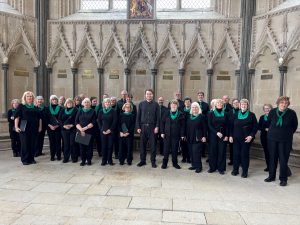 Unlimited Voices choir stand together in concert attire.